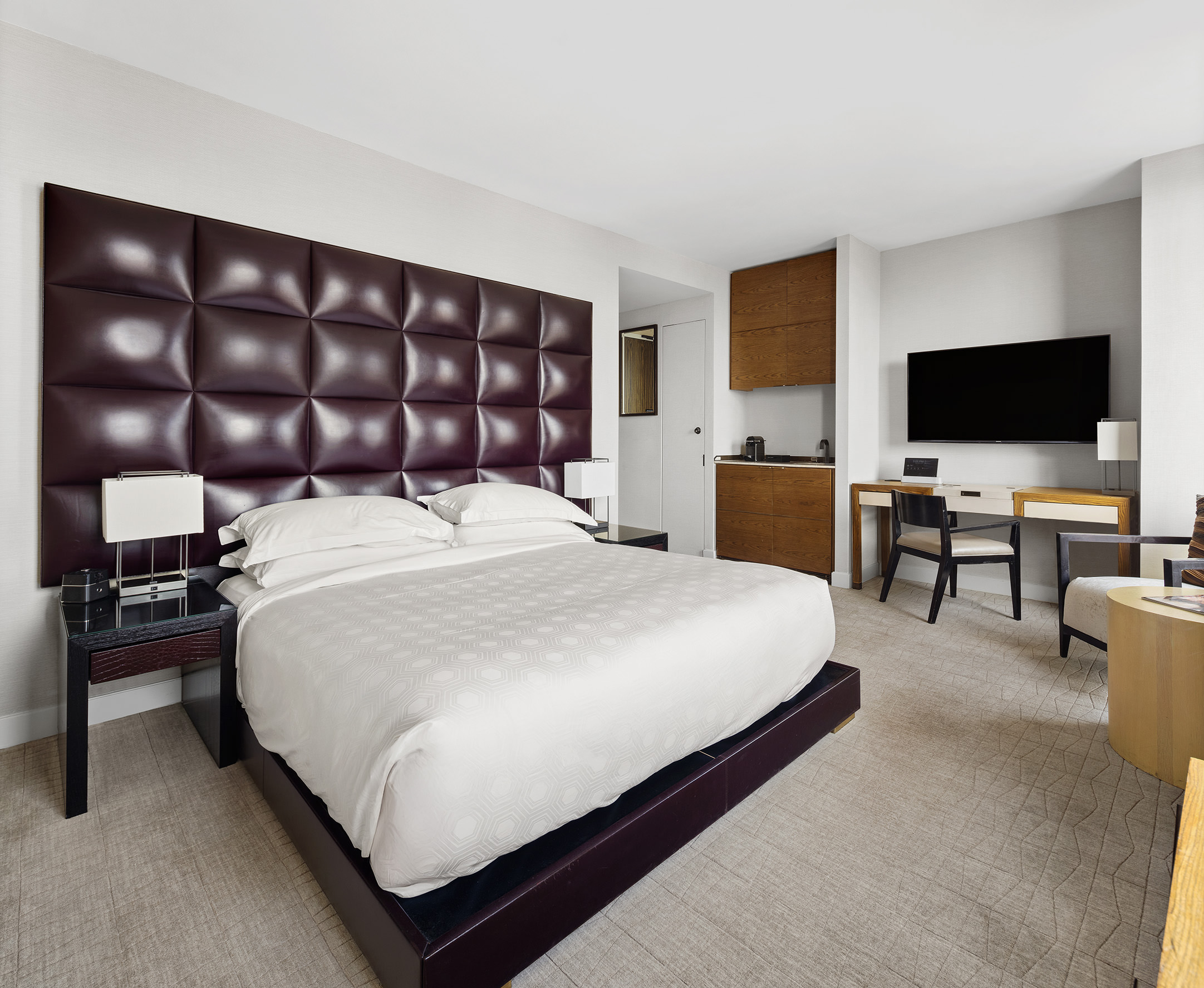 246 Spring Street, Unit 4104 Manhattan, NY 10013 - Photo 3 of 8 a large bedroom with a bed and a flat screen tv