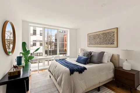 a bedroom with a large bed and a large window