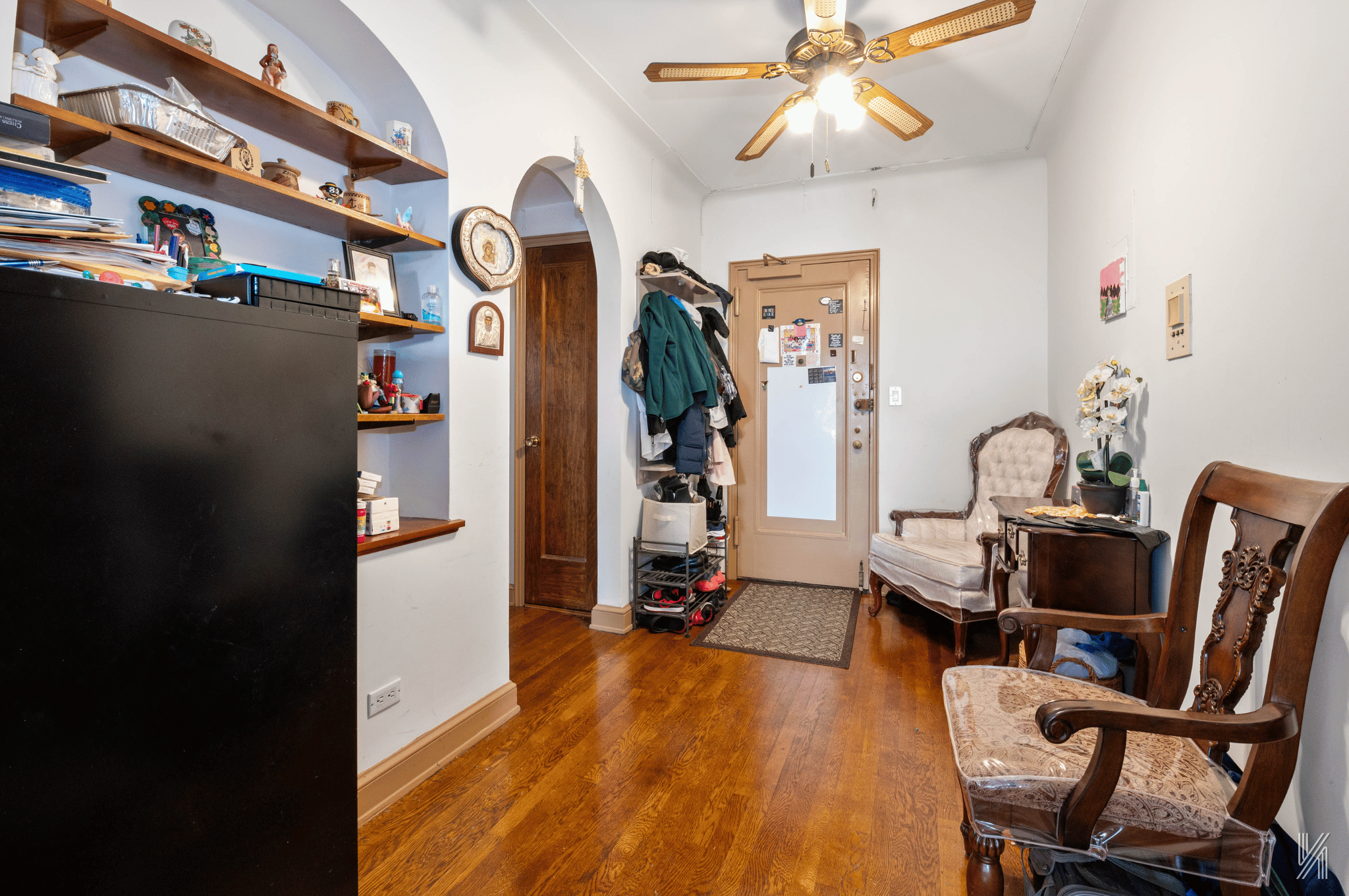 25-40 31st Avenue, Unit 6M Queens, NY 11106 - Photo 6 of 17 a view of a workspace with furniture and a ceiling fan