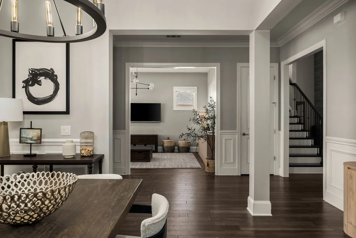 a living room with furniture a flat screen tv and a large window