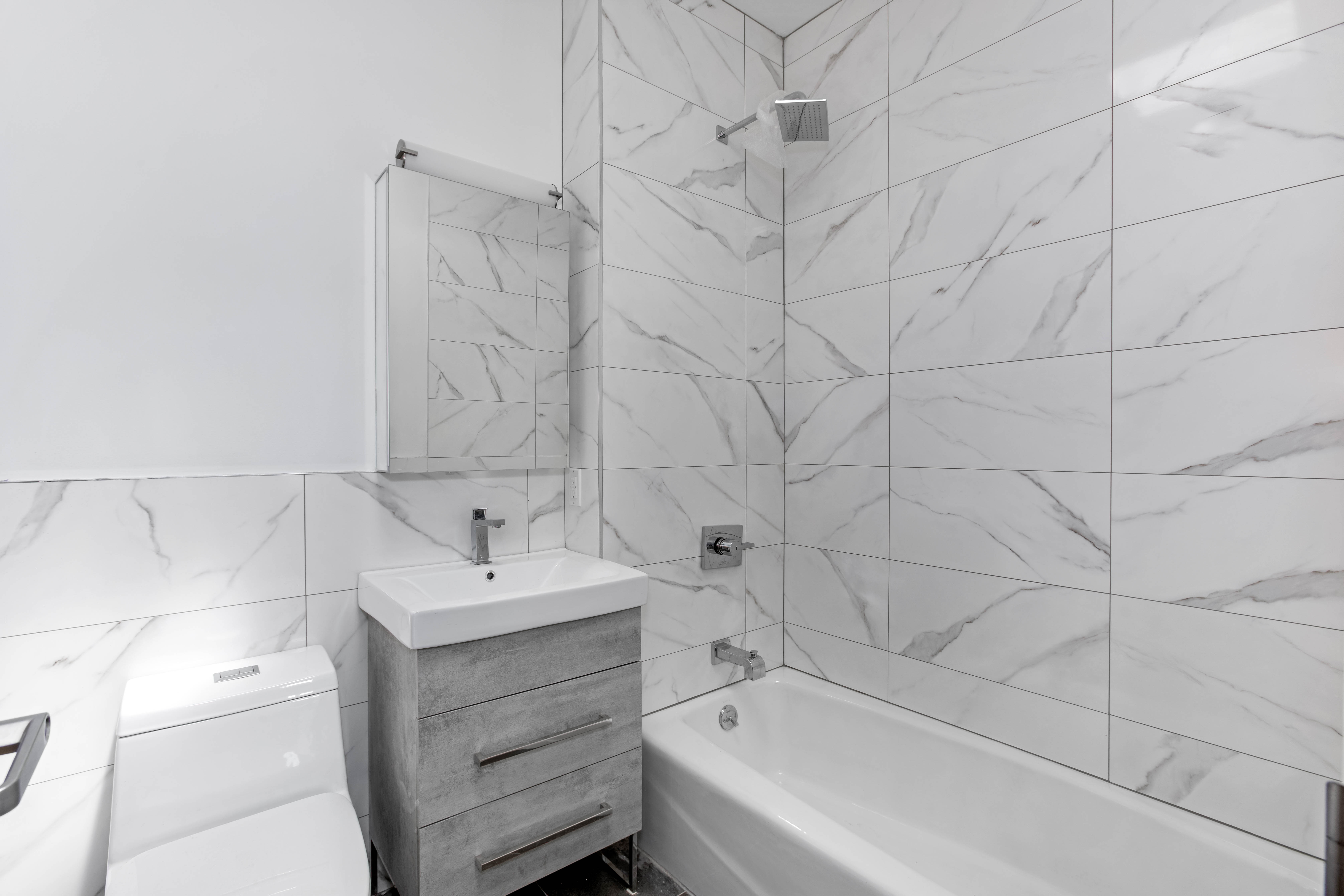 110 Bushwick Avenue, Unit 3 Brooklyn, NY 11206 - Photo 6 of 7 a bathroom with a sink and a bathtub