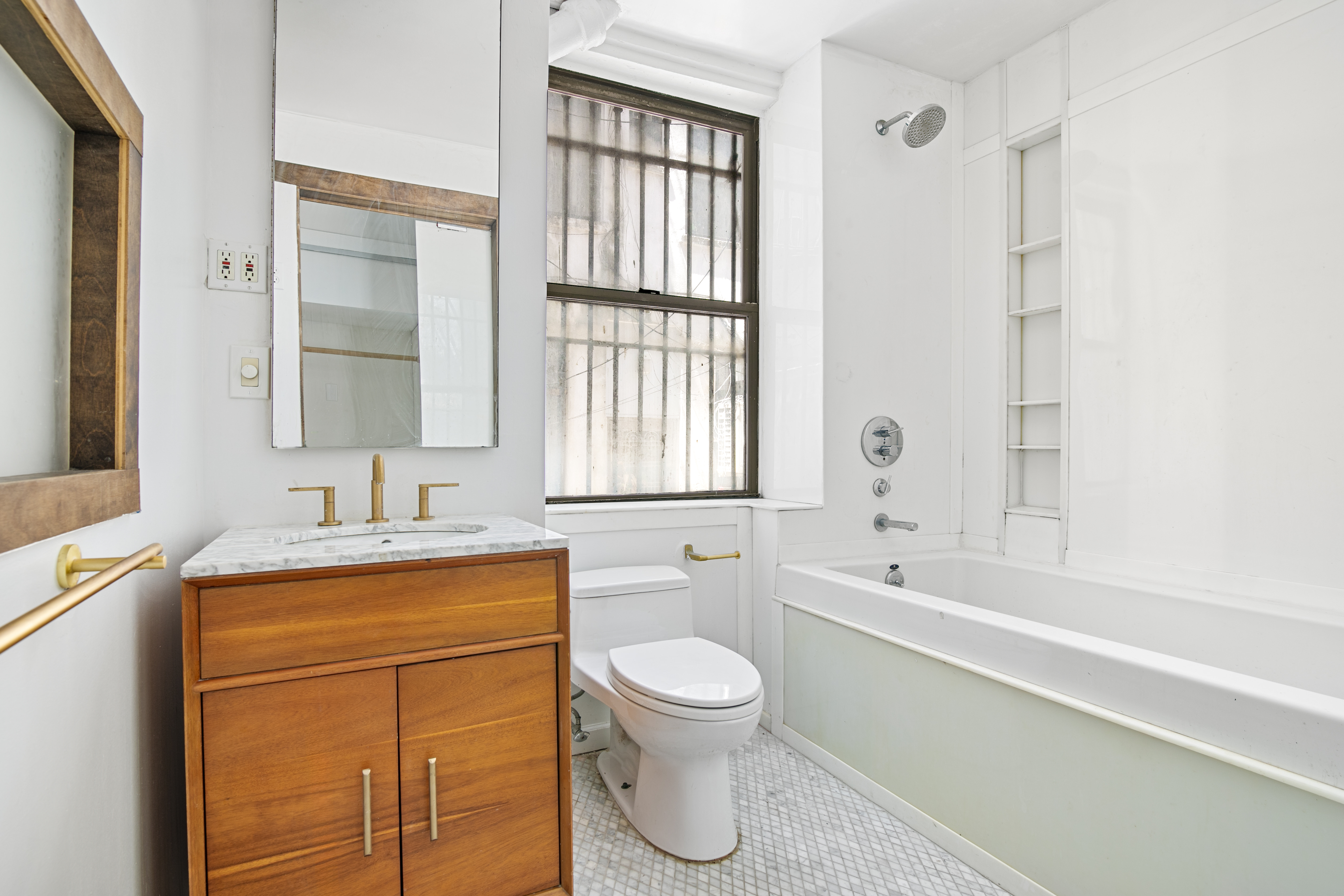 305 East 4th Street, Unit GARDEN Manhattan, NY 10009 - Photo 6 of 8 a bathroom with a granite countertop sink toilet and shower