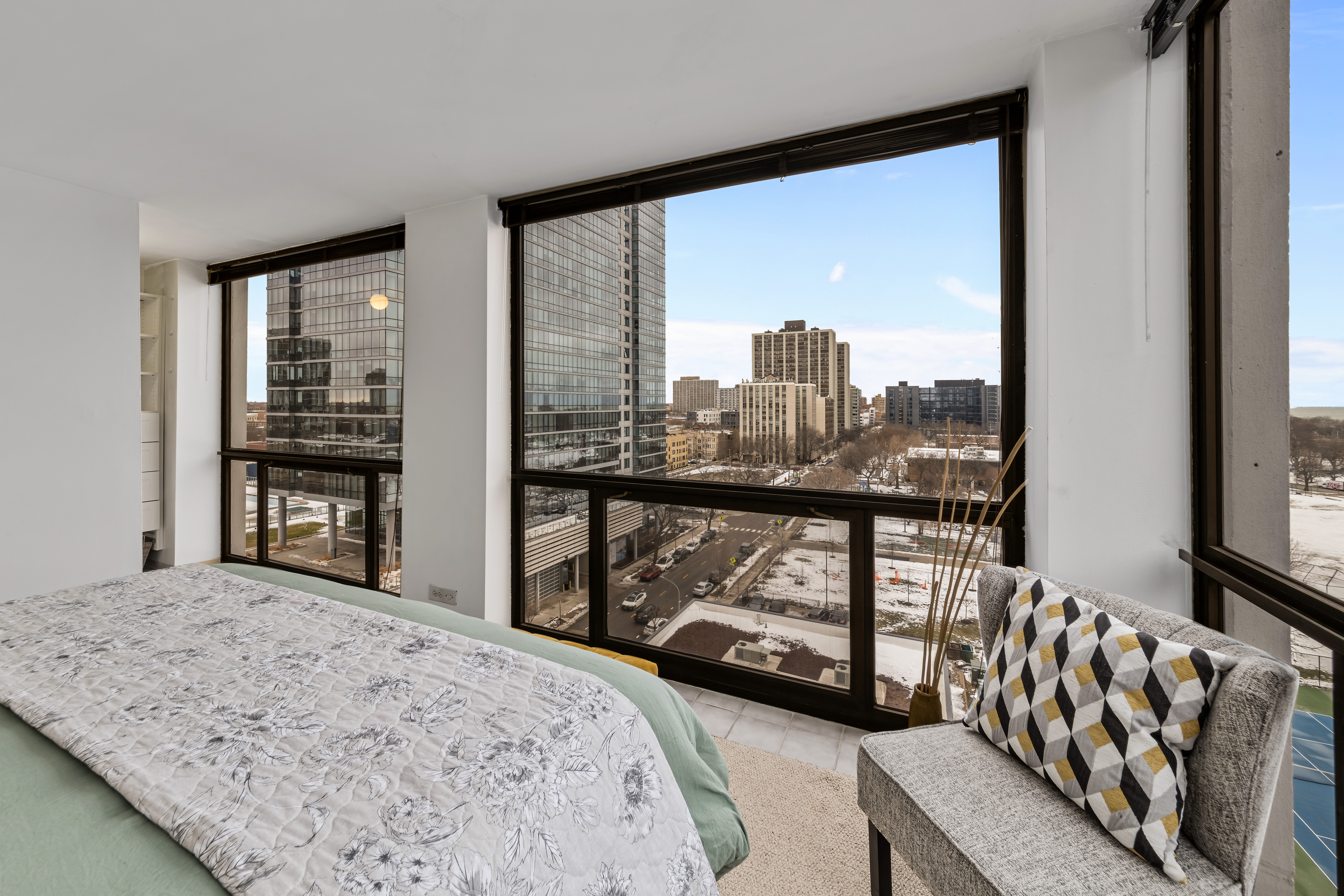 4343 North Clarendon Avenue, Unit 1016 Chicago, IL 60613 - Photo 23 of 35 a bedroom with furniture and large windows