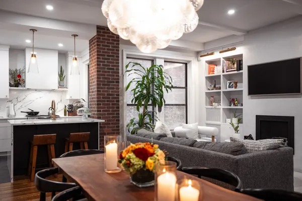 a living room with furniture a flat screen tv and a fireplace