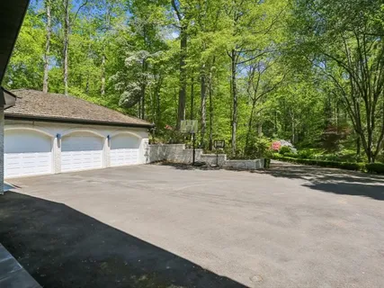 a front view of a house with a garden and garage