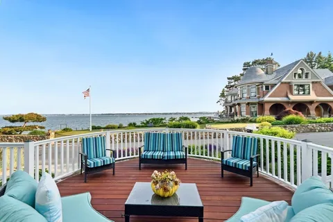 a view of a roof deck with furniture