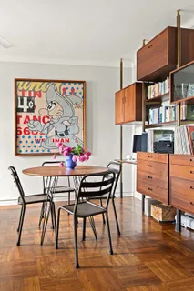 a view of a dining room with furniture and a book shelf