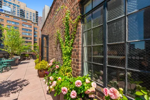 a bunch of flowers in front of a building