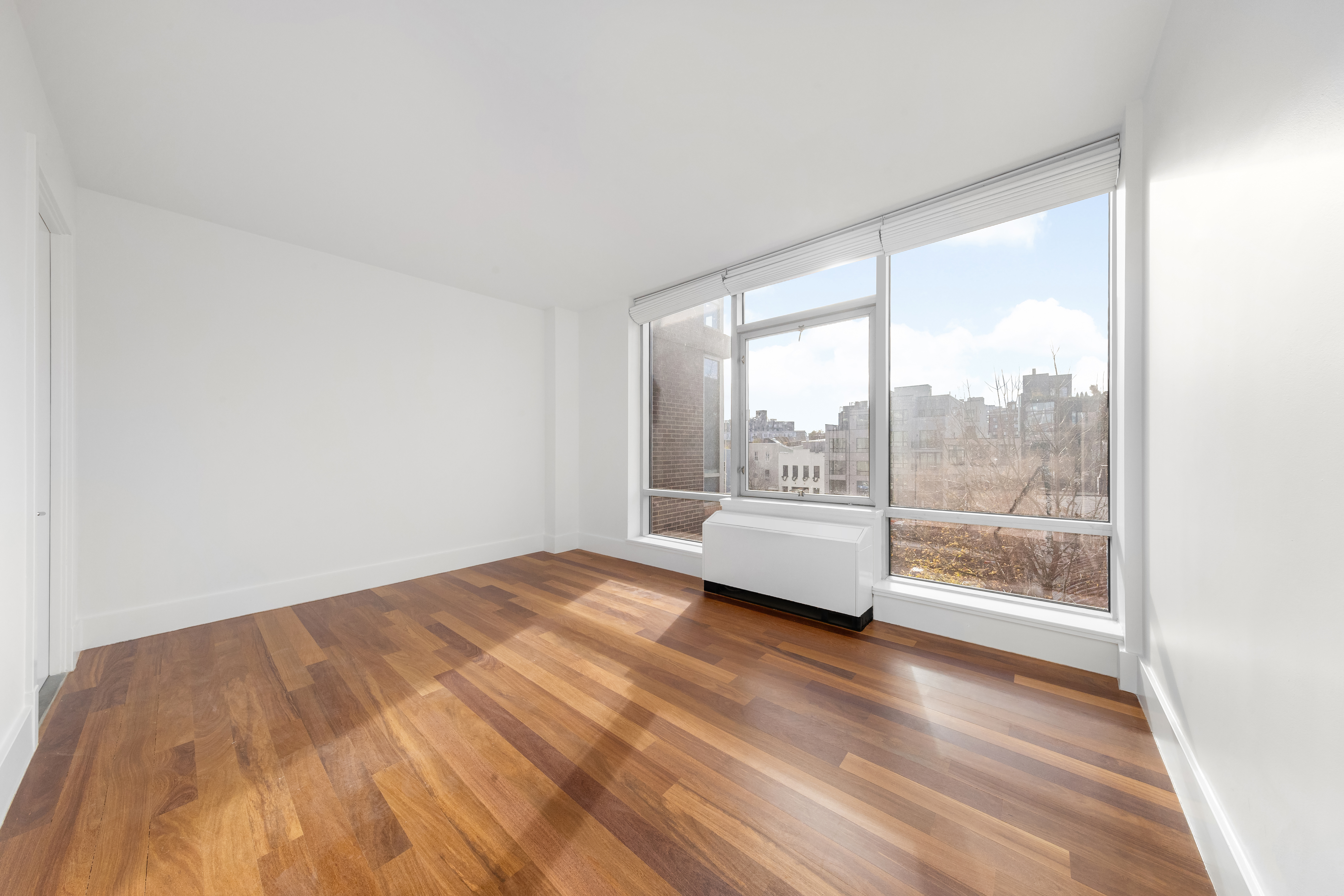 30 Bayard Street, Unit 4F Brooklyn, NY 11211 - Photo 5 of 12 a view of empty room with wooden floor and fan
