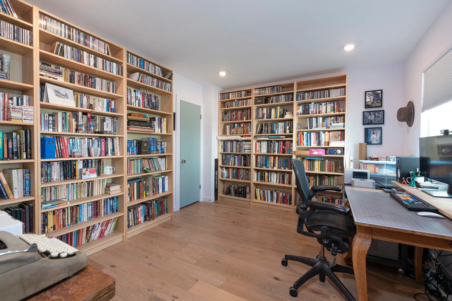 a view of a workspace with bookshelf