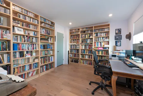 a view of a workspace with bookshelf