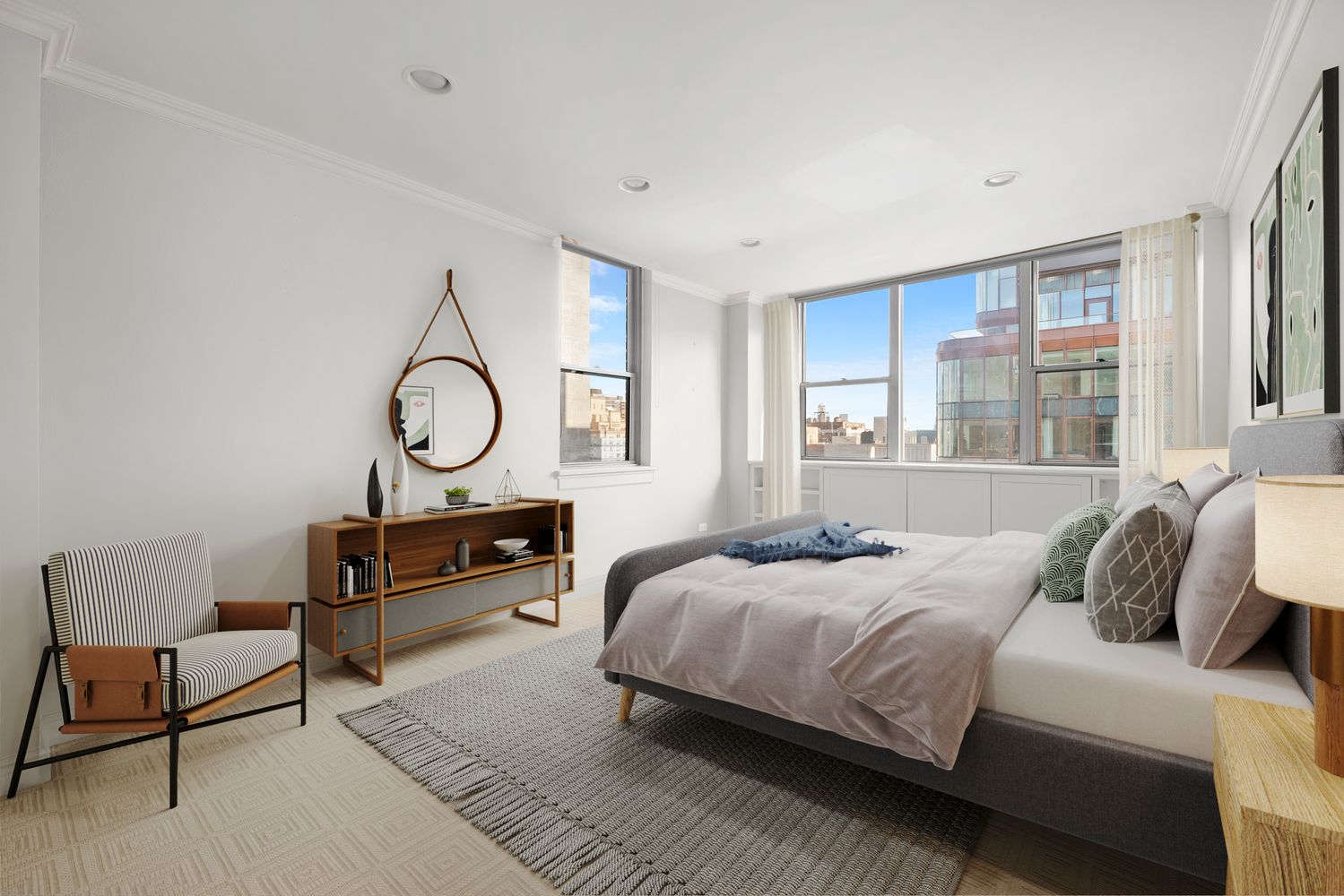 a bedroom with a bed a mirror and a large window with outer view