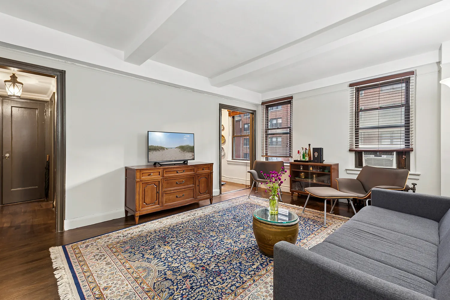a living room with furniture and a flat screen tv