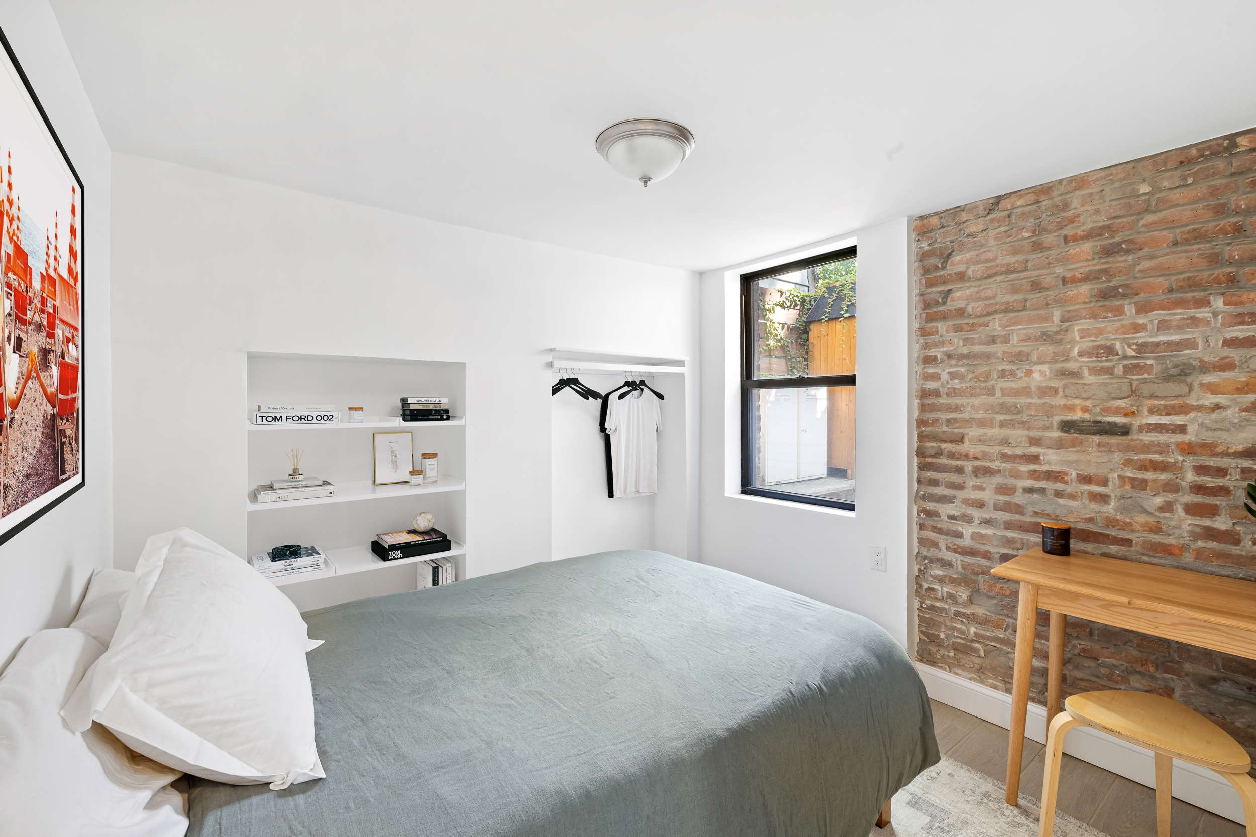 716 Monroe Street Brooklyn, NY 11221 - Photo 18 of 22 a bedroom with a bed and a window
