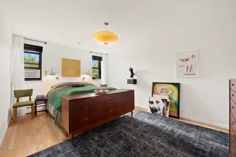 a bed room with a bed and a chair