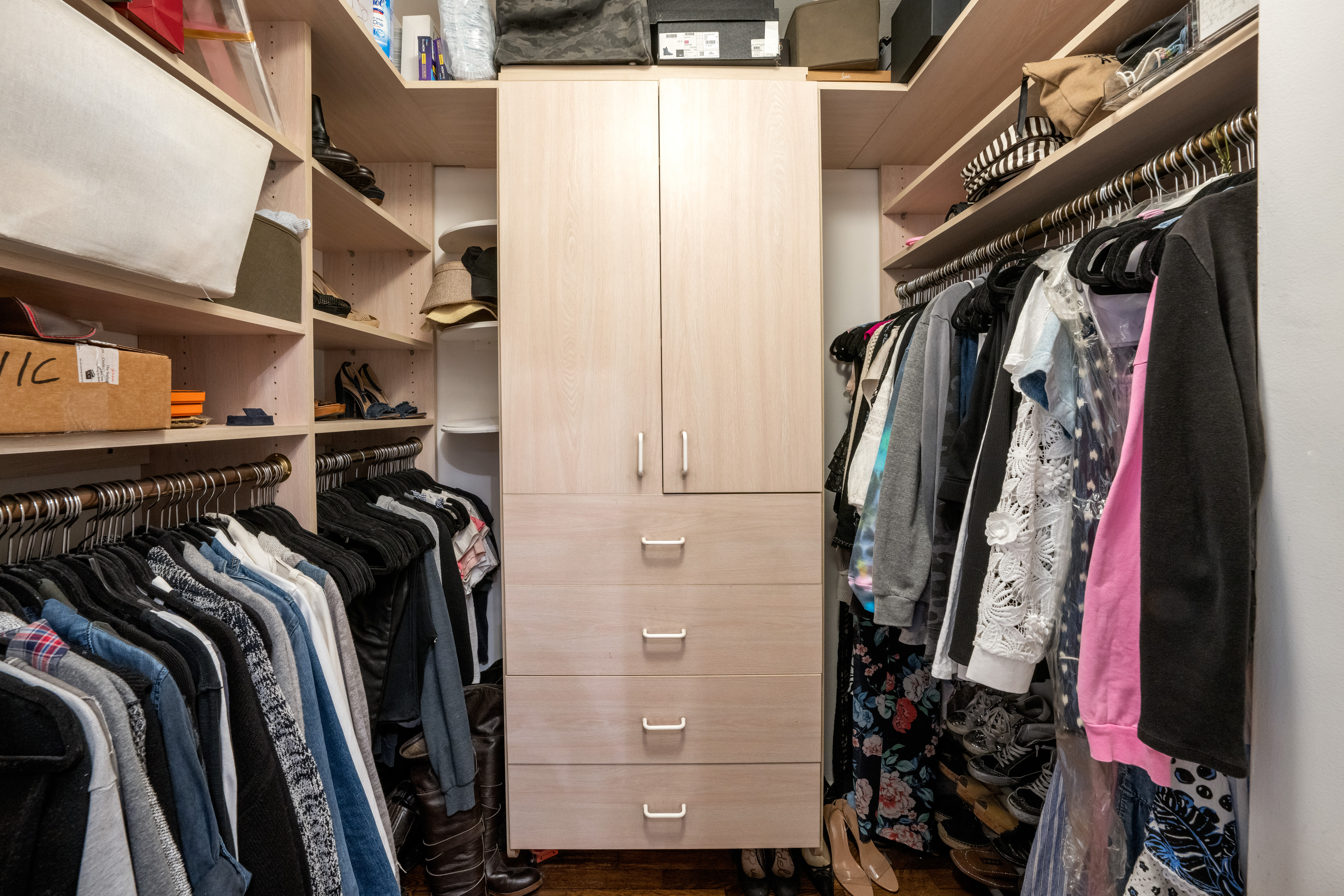 345 East 56th Street, Unit 11C Manhattan, NY 10022 - Photo 6 of 15 a view of walk in closet with clothes and shoes
