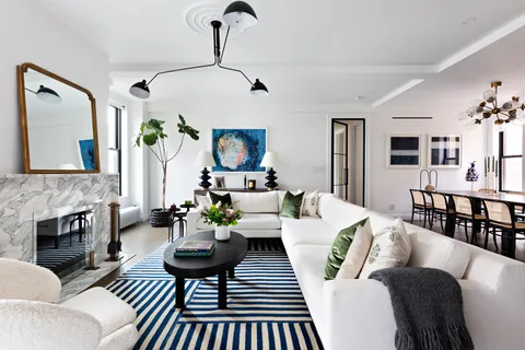 a living room with furniture fireplace and a table