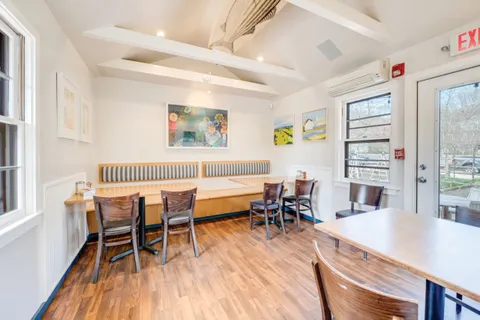 a dining room with furniture and wooden floor