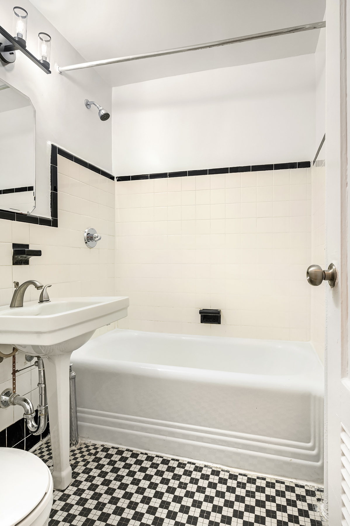 195 Prince Street, Unit 2W Manhattan, NY 10012 - Photo 4 of 9 a bathroom with a bathtub and a shower