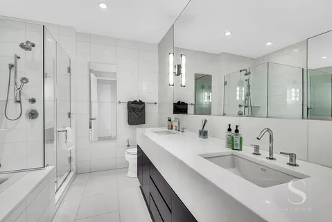 a bathroom with a bathtub and a shower