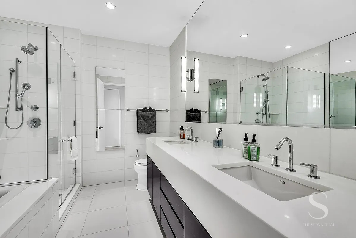 4 West 21st Street, Unit 14A Manhattan, NY 10010 - Photo 8 of 16 a bathroom with a double vanity sink mirror and shower