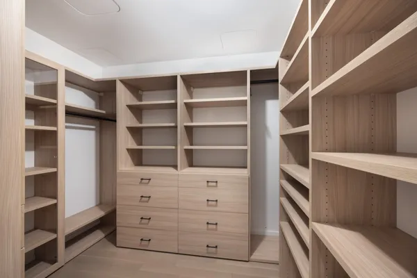 a view of walk in closet with empty racks