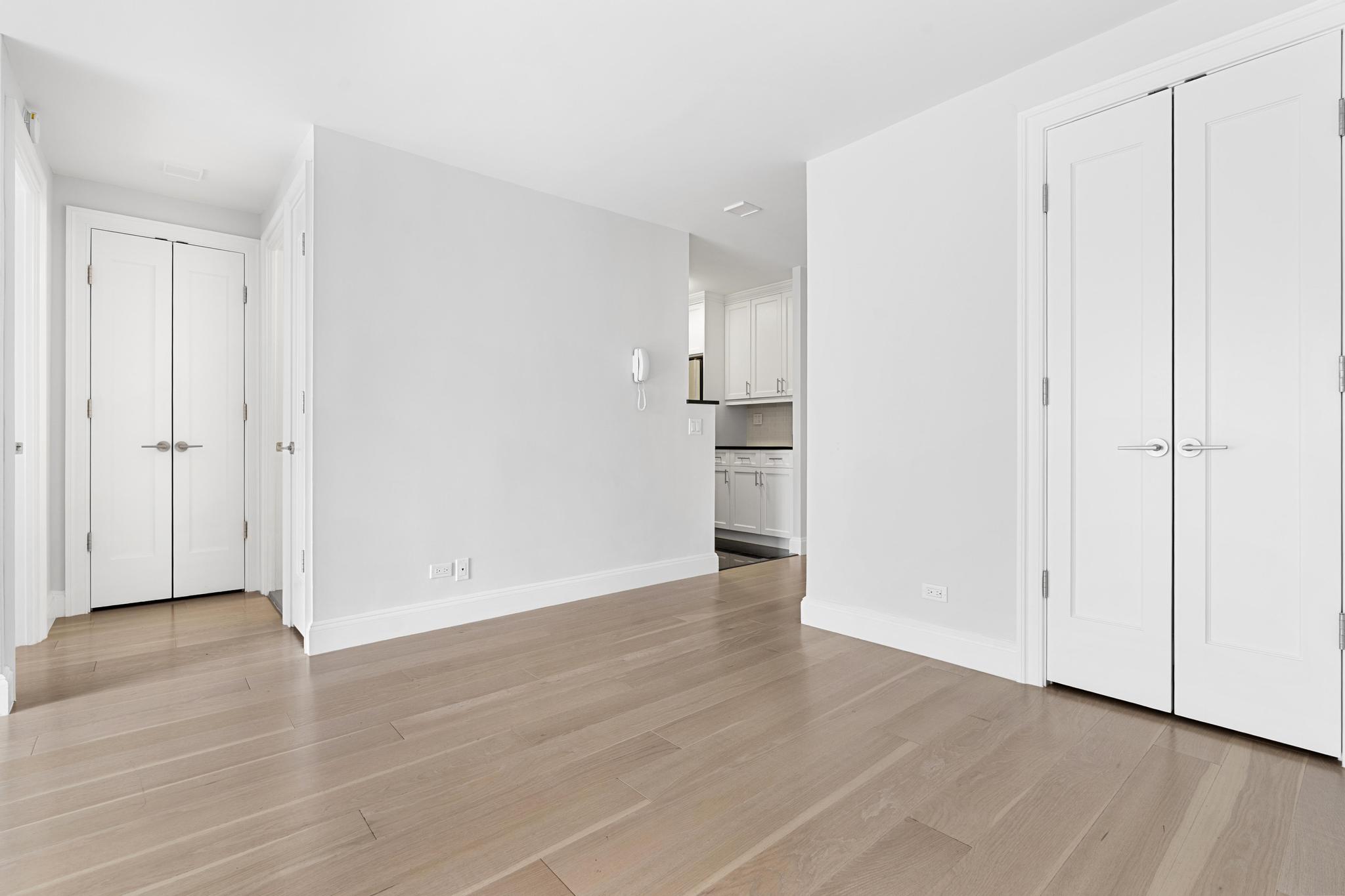 155 West 68th Street, Unit 1027 Manhattan, NY 10023 - Photo 7 of 8 a view of empty room with wooden floor