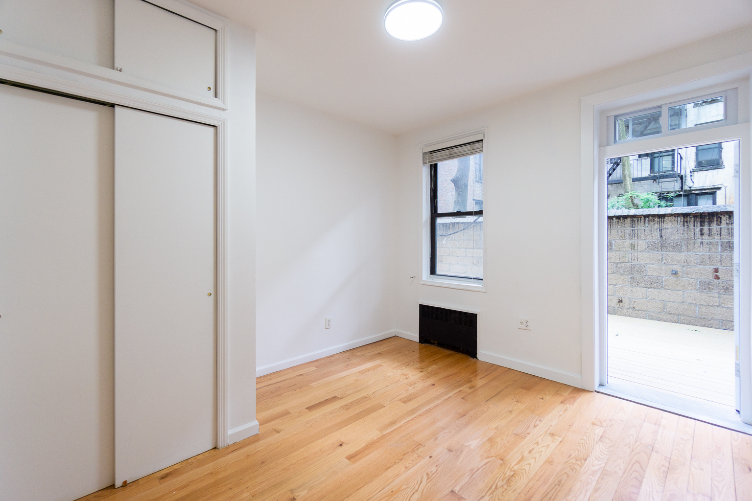 315 East 5th Street, Unit 1C Manhattan, NY 10003 - Photo 6 of 15 a view of empty room with wooden floor