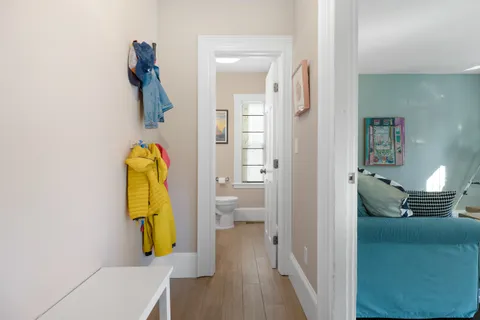 a bathroom with a toilet a sink and mirror