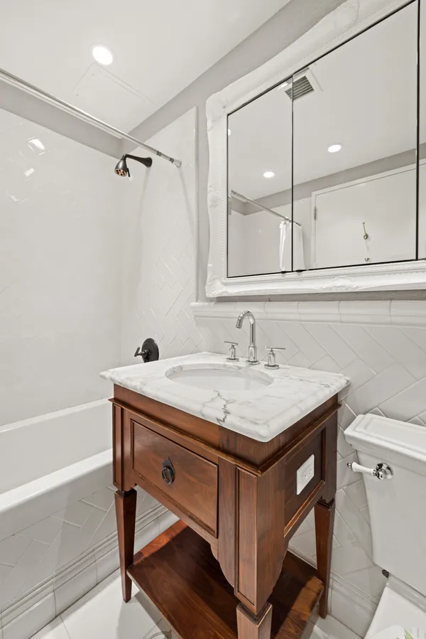 a bathroom with a sink a vanity and a bathtub