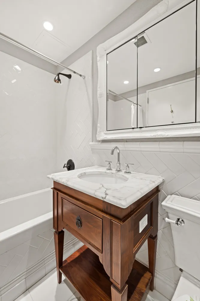 a bathroom with a sink a vanity and a bathtub