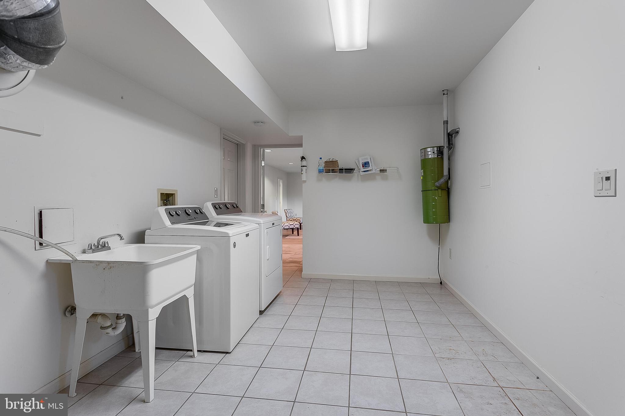 4709 Foxhall Crescent Northwest Washington, DC 20007 - Photo 55 of 57 a view of utility room with closet dryer and washer