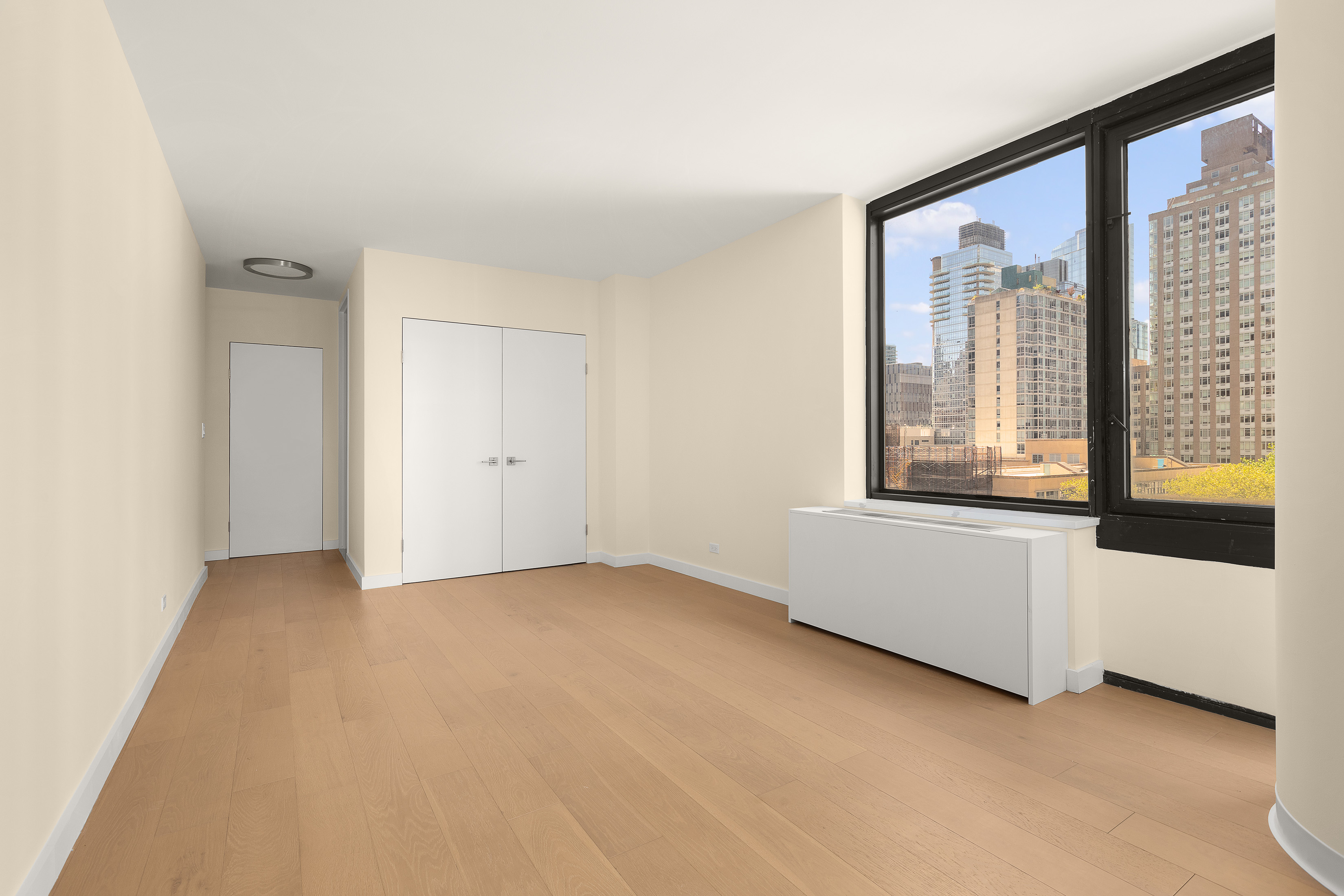 161 West 61st Street, Unit 5C Manhattan, NY 10023 - Photo 17 of 30 an empty room with windows