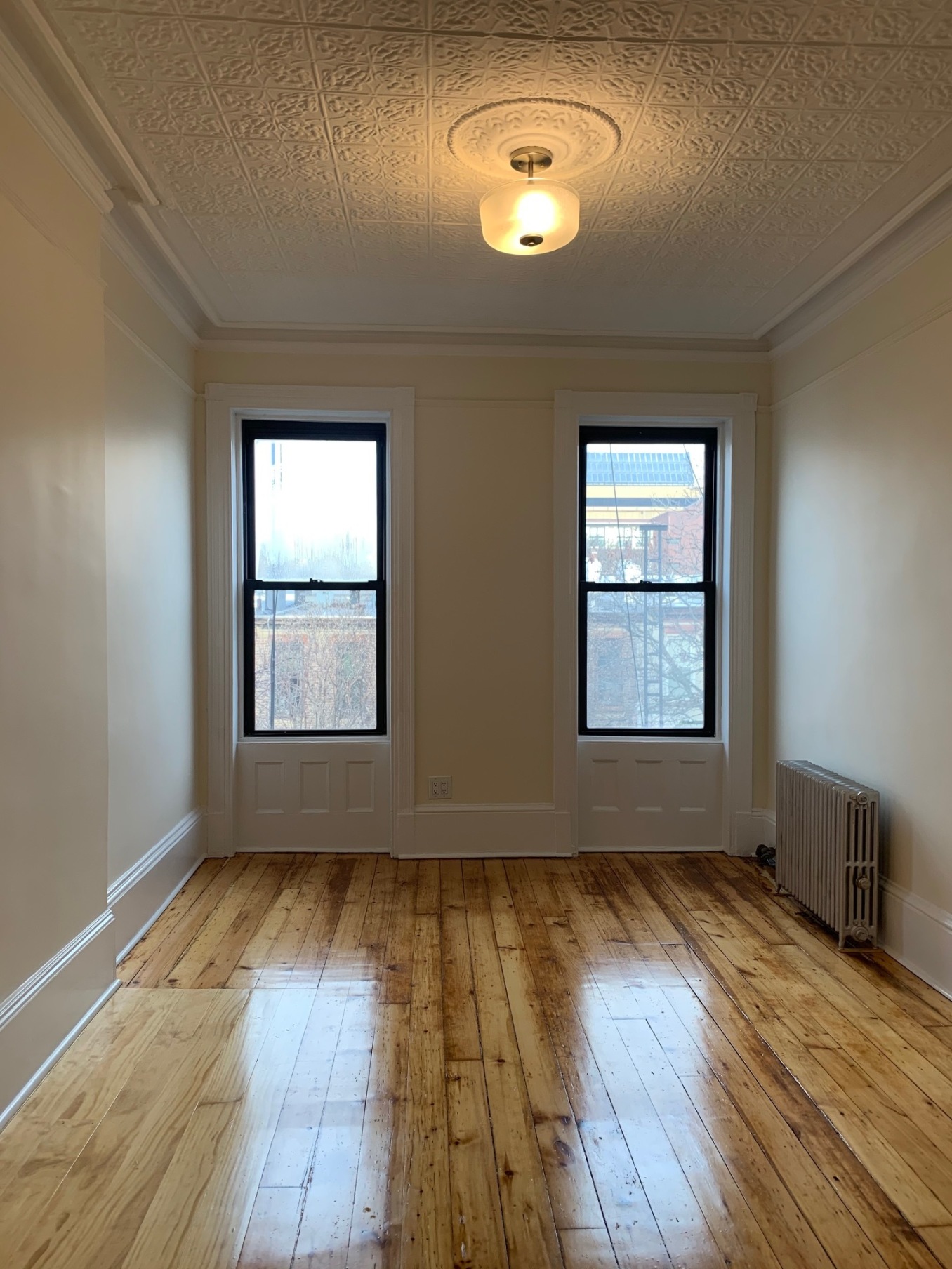 481 9th Street, Unit 4 Brooklyn, NY 11215 - Photo 16 of 33 an empty room with wooden floor and windows