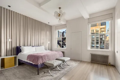 a bedroom with a bed dresser and a window