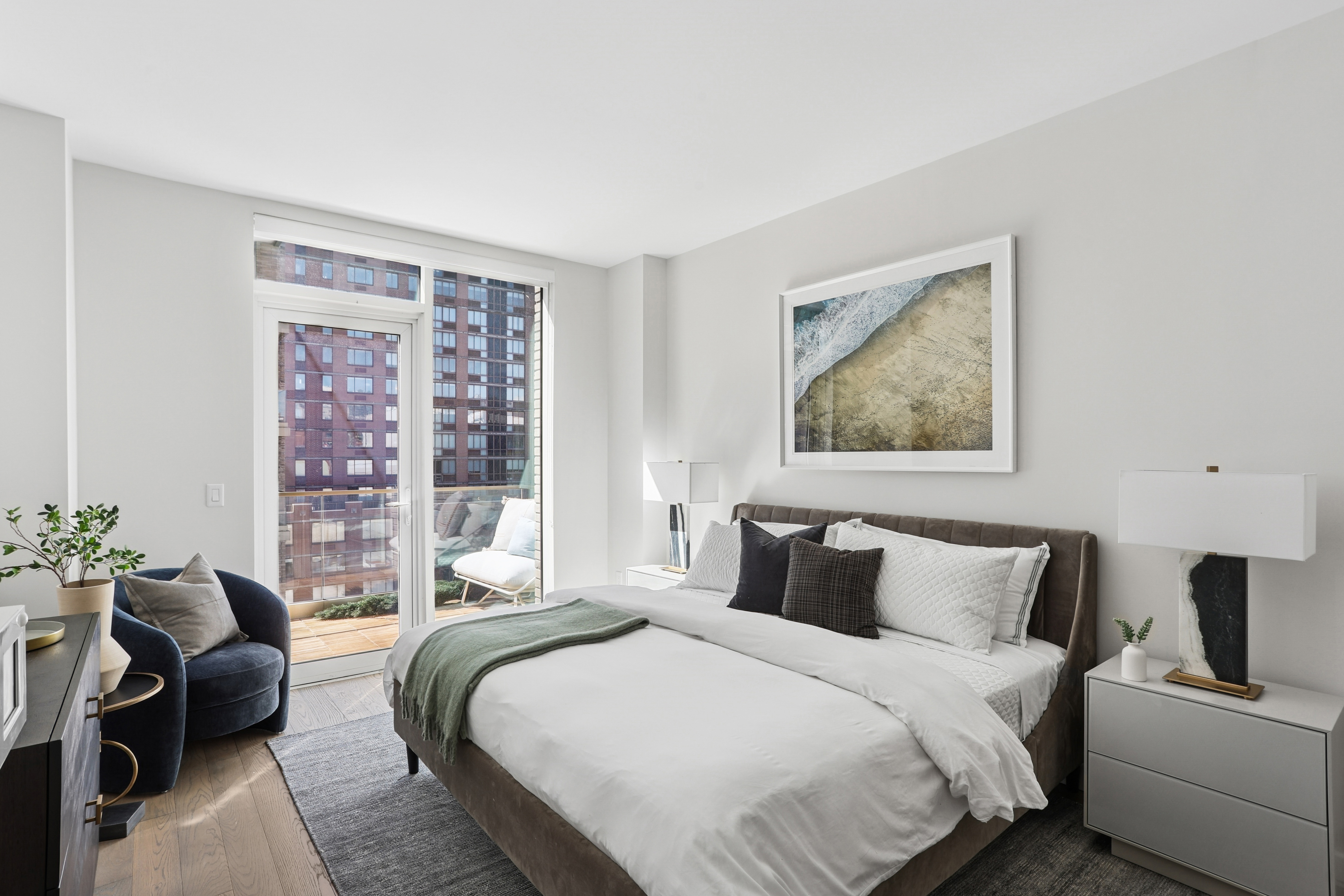 505-513 West 43rd Street, Unit 10B Manhattan, NY 10036 - Photo 7 of 22 a bedroom with a bed and a couch