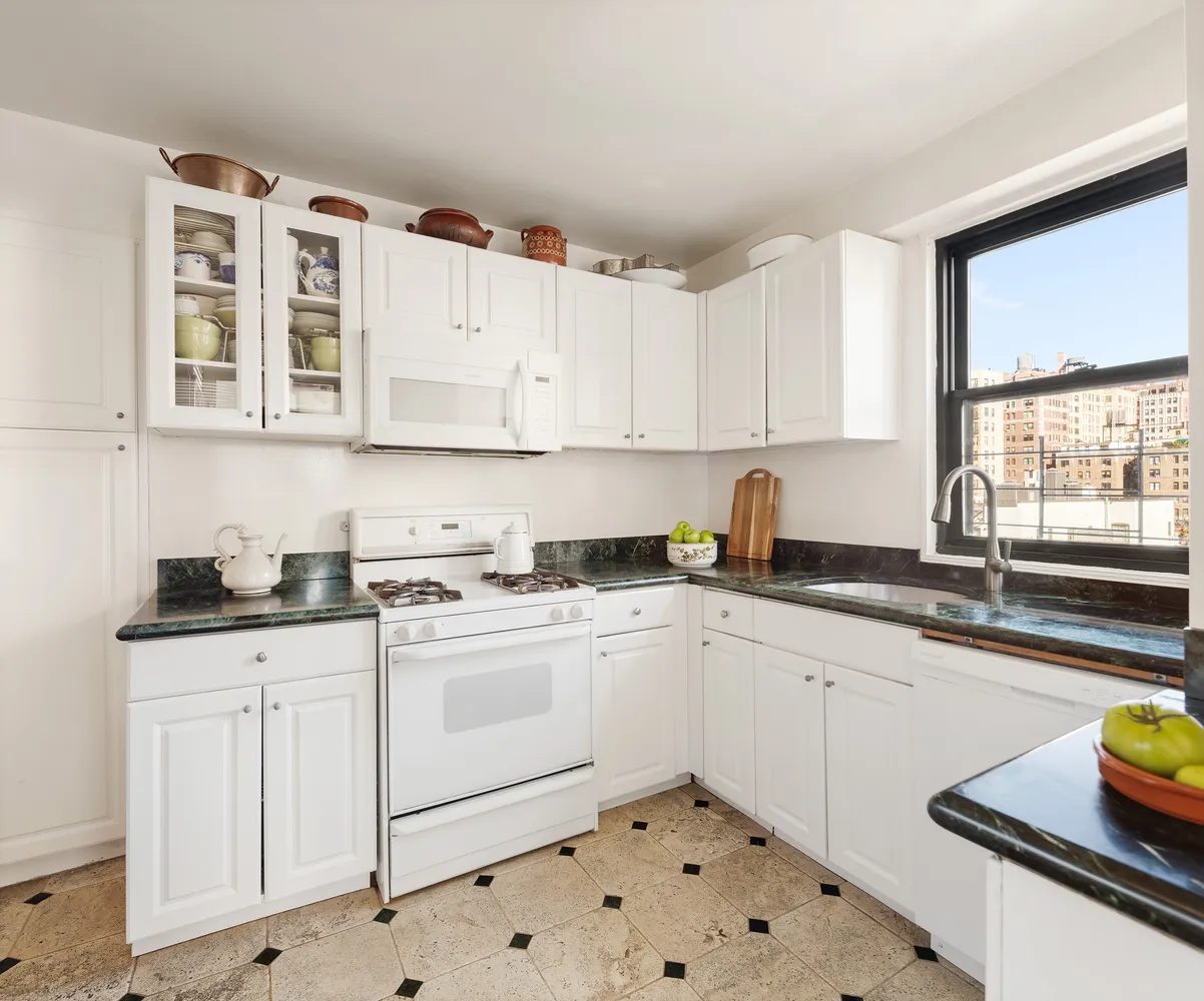 a kitchen with granite countertop a sink and cabinets
