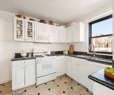 a kitchen with granite countertop a sink and cabinets