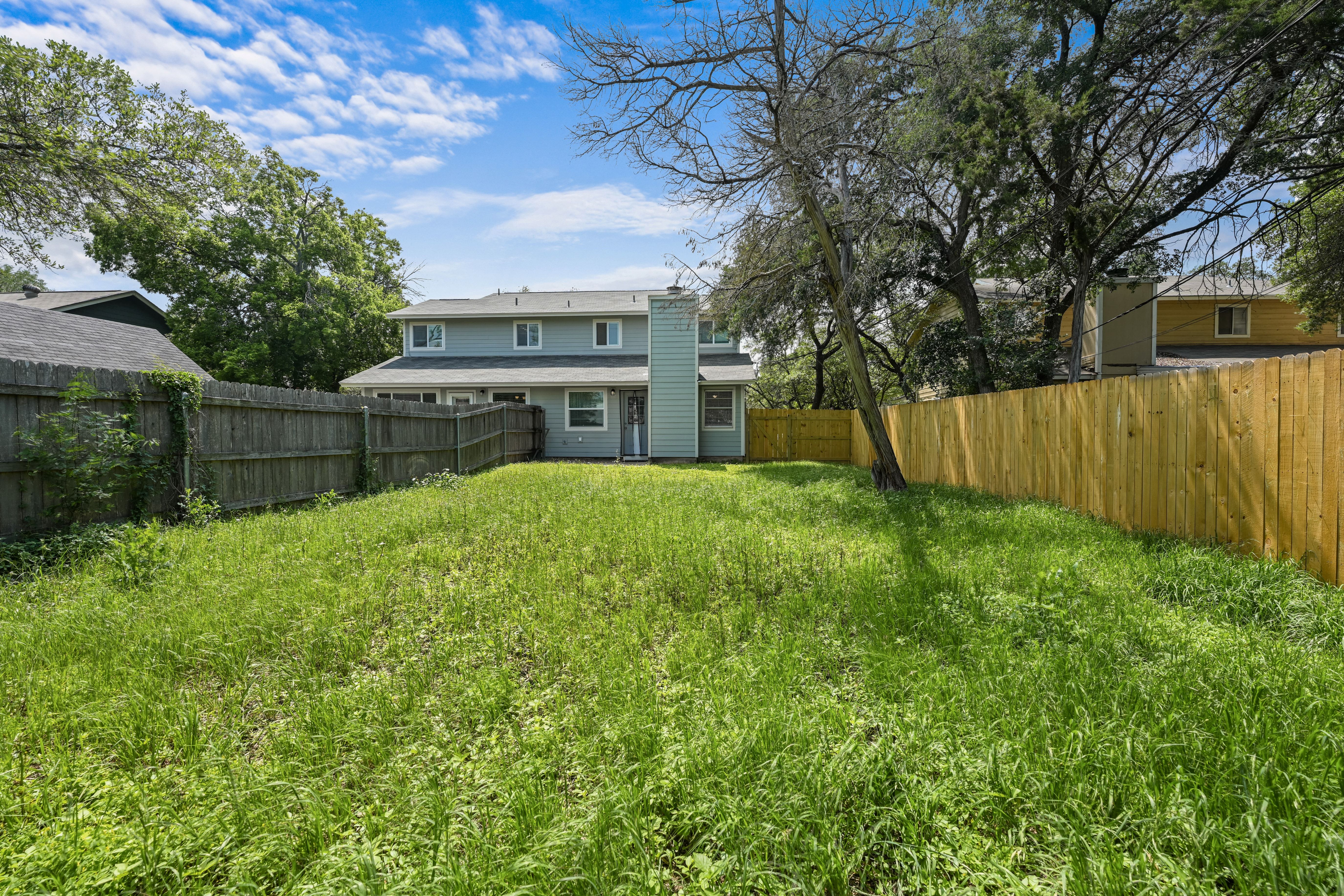 8710 Clearbrook Trail Austin, TX 78729 - Photo 25 of 28 a view of a house with a big yard and a large tree