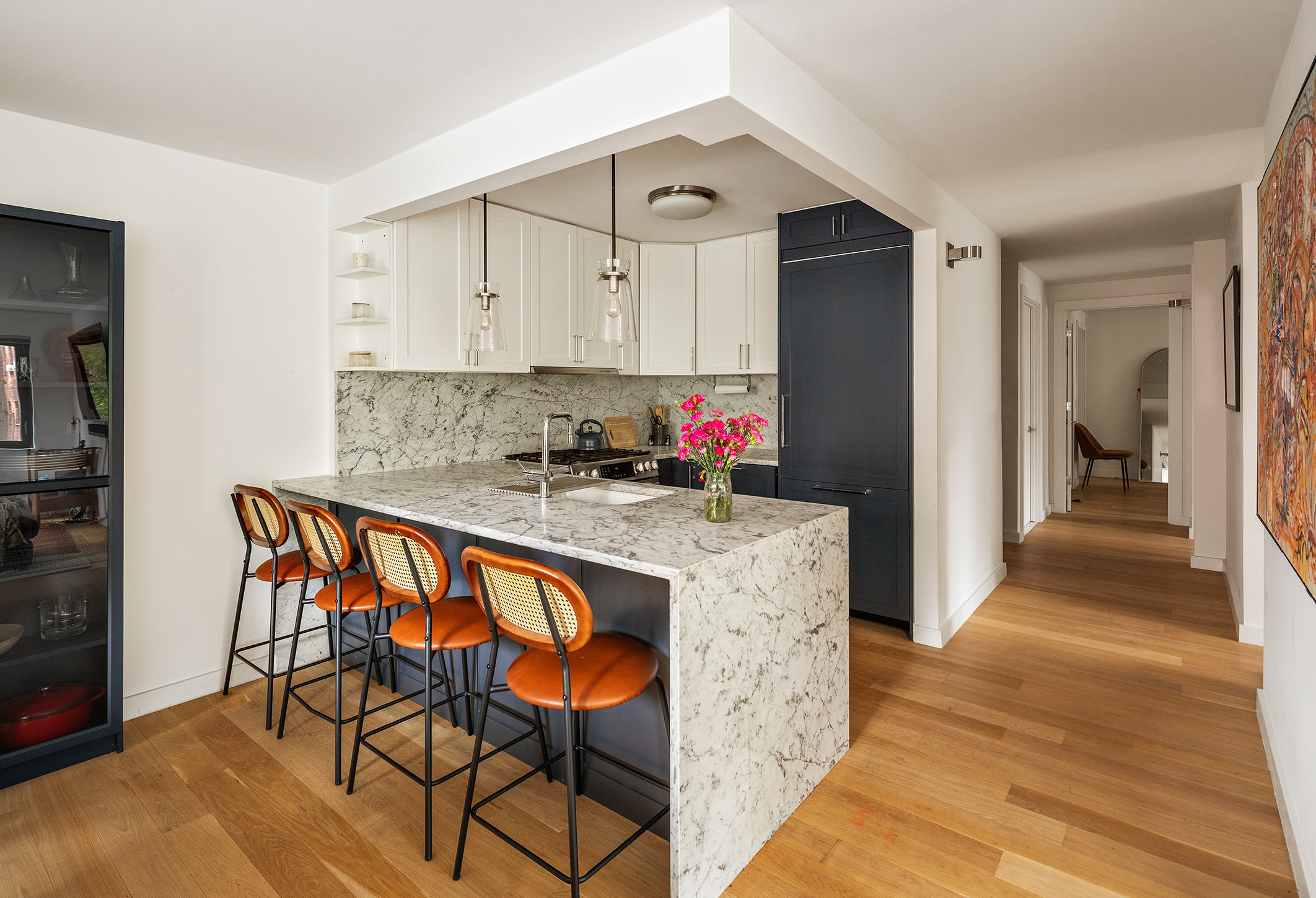 a kitchen with granite countertop a table chairs refrigerator and cabinets