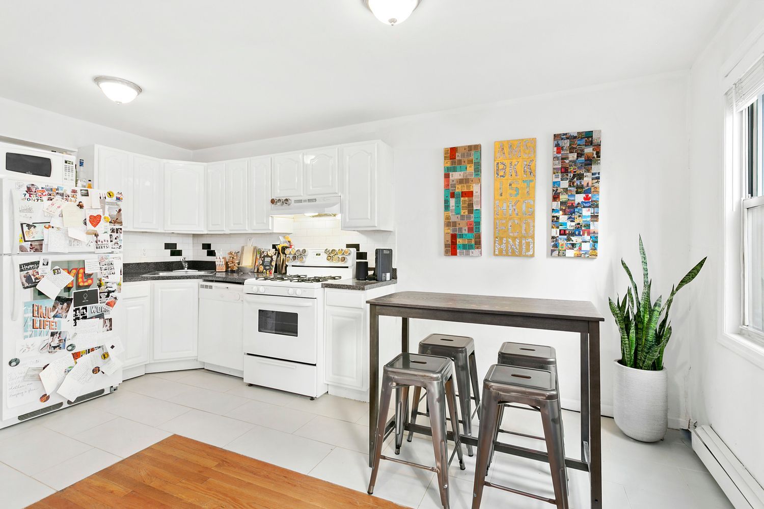 a kitchen with white cabinets and white appliances