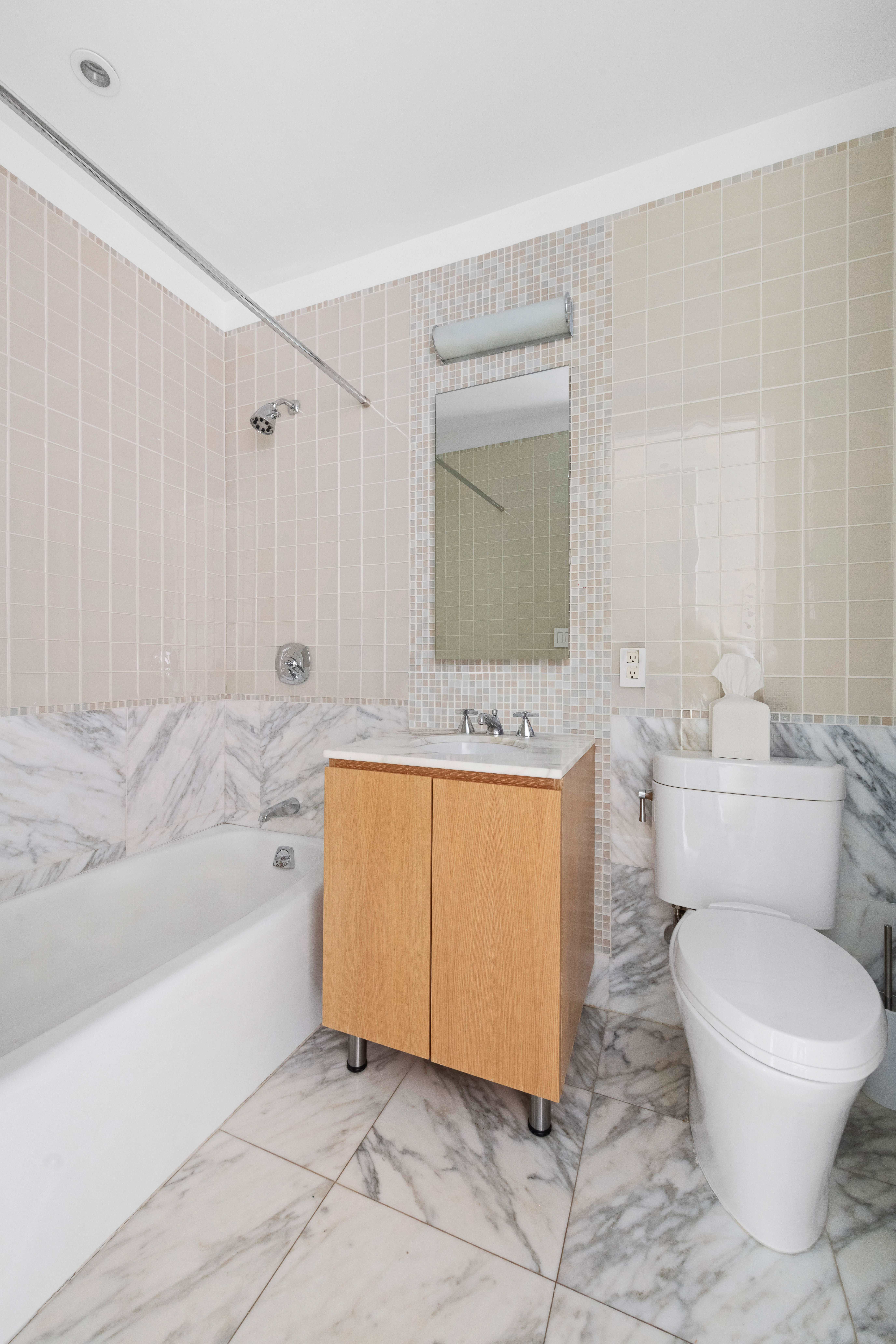 255 East 74th Street, Unit 14C Manhattan, NY 10021 - Photo 11 of 14 a bathroom with a sink a toilet and bathtub