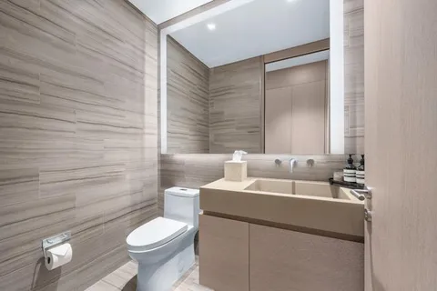 a bathroom with a toilet sink and mirror