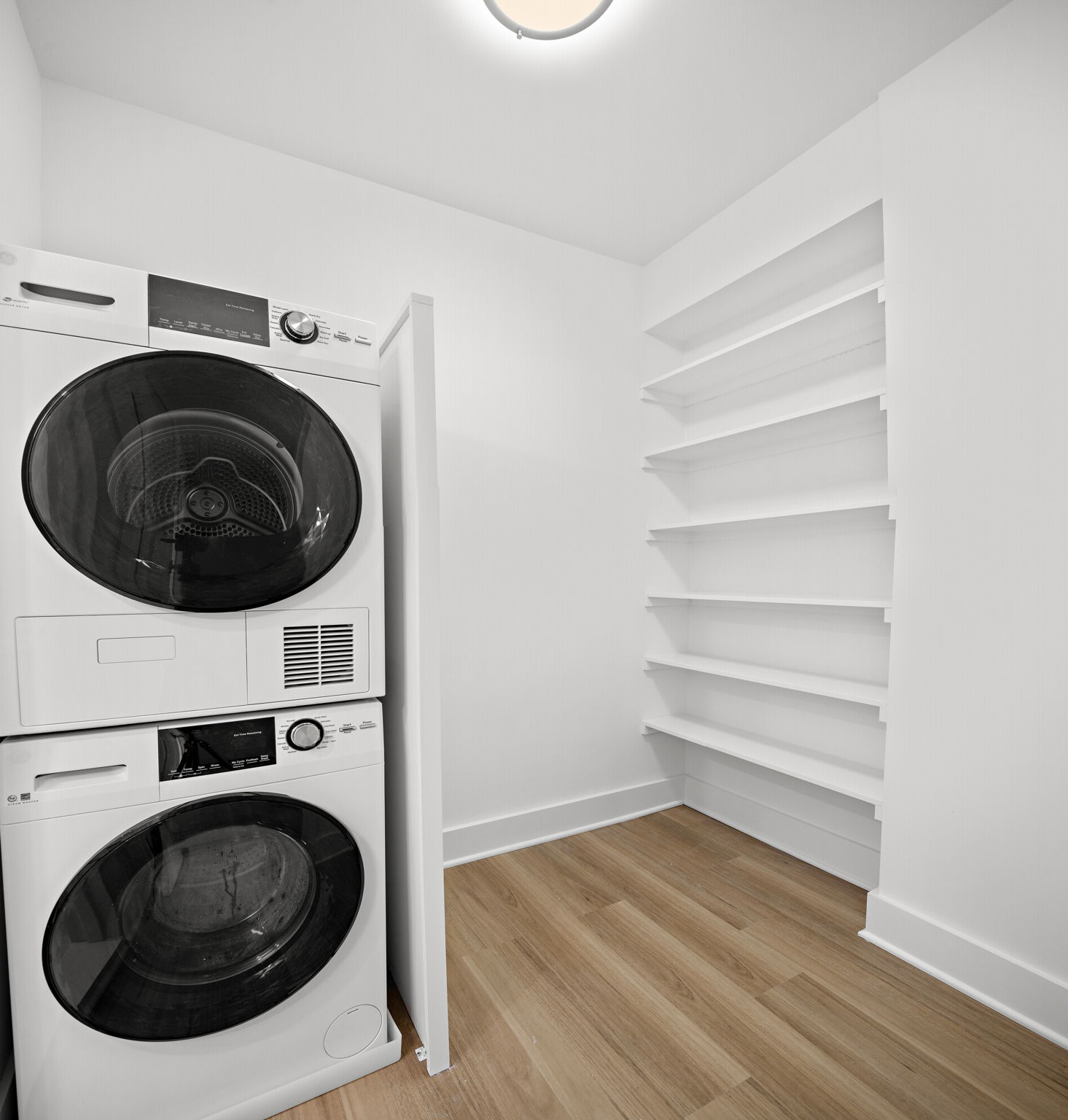 400 East 54th Street, Unit 19H Manhattan, NY 10022 - Photo 10 of 15 a view of a washer and dryer in a utility room