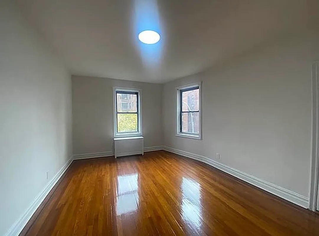 625 Caton Avenue, Unit 4E Brooklyn, NY 11218 - Photo 8 of 12 an empty room with wooden floor and windows