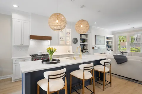 a kitchen with a table chairs and wooden floor