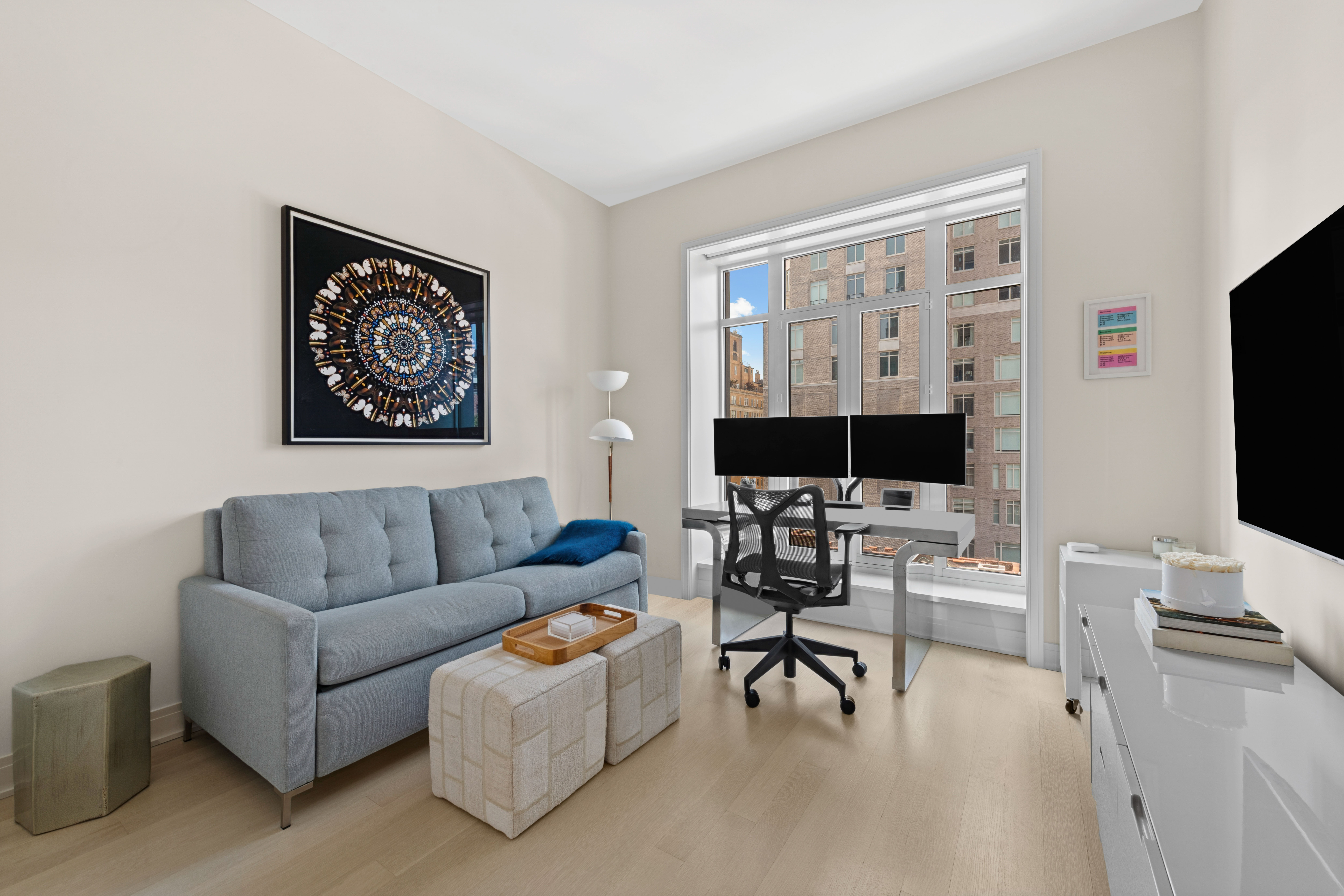 40 East End Avenue, Unit 9B Manhattan, NY 10028 - Photo 9 of 25 a living room with furniture a flat screen tv and a large window