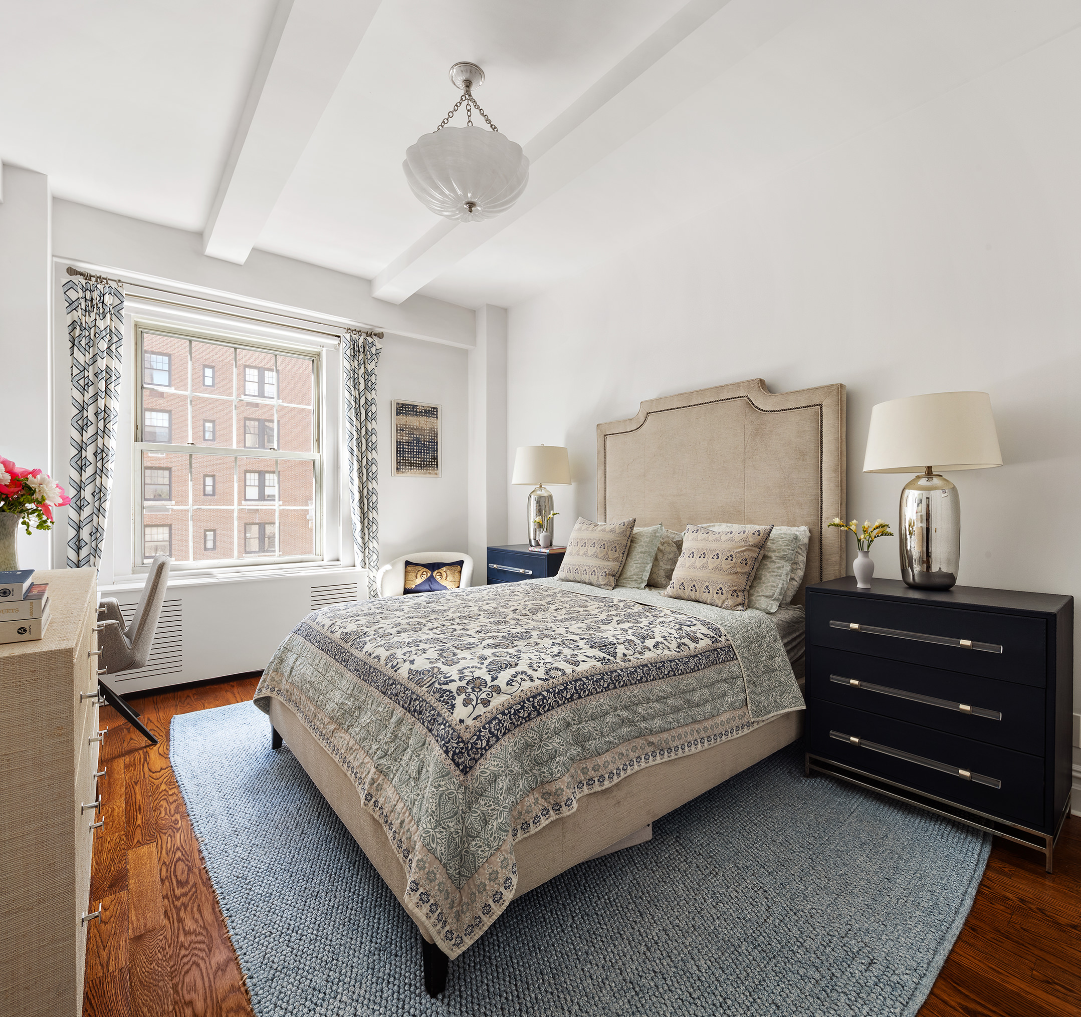 25 5th Avenue, Unit 8F Manhattan, NY 10003 - Photo 7 of 9 a bedroom with a bed and wooden floor