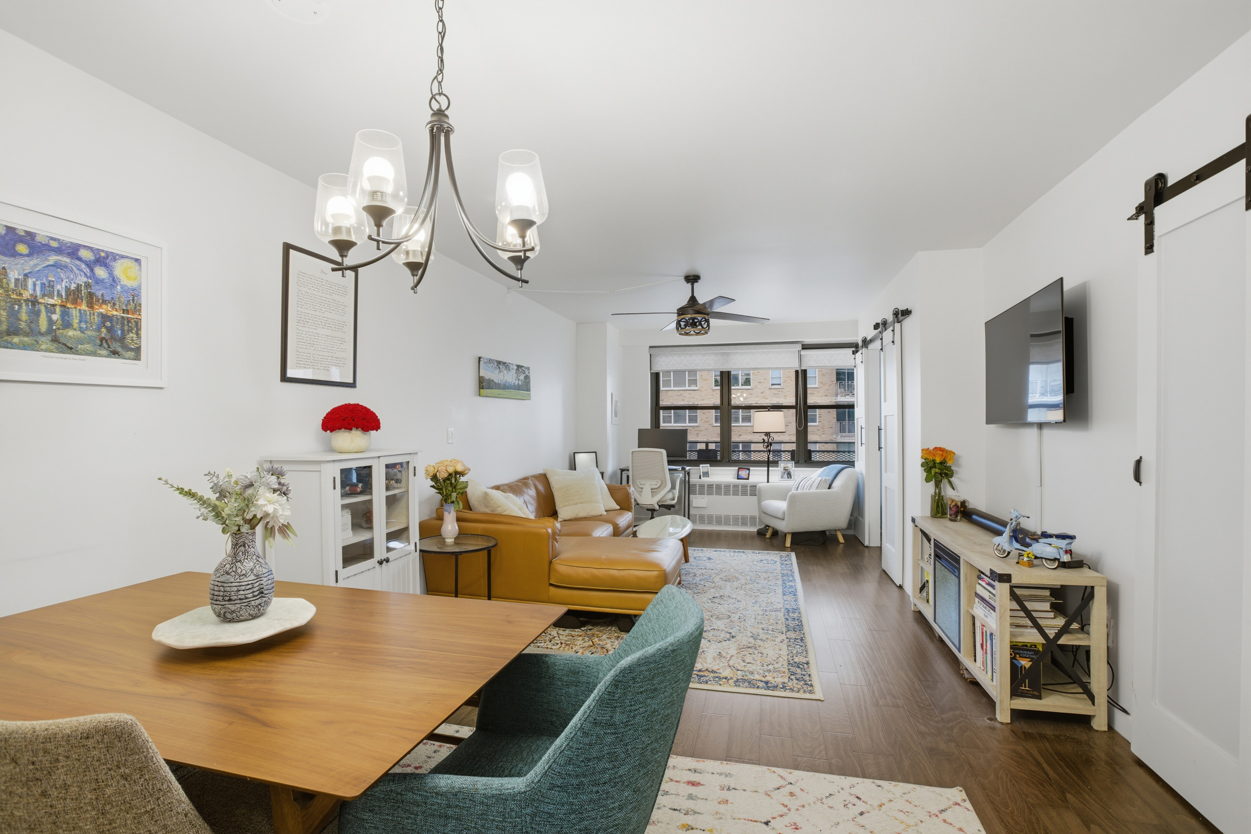 345 East 81st Street, Unit 9D Manhattan, NY 10028 - Photo 13 of 17 a living room with furniture and a flat screen tv