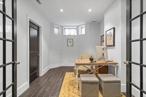 a front view of a house with balcony and outdoor seating